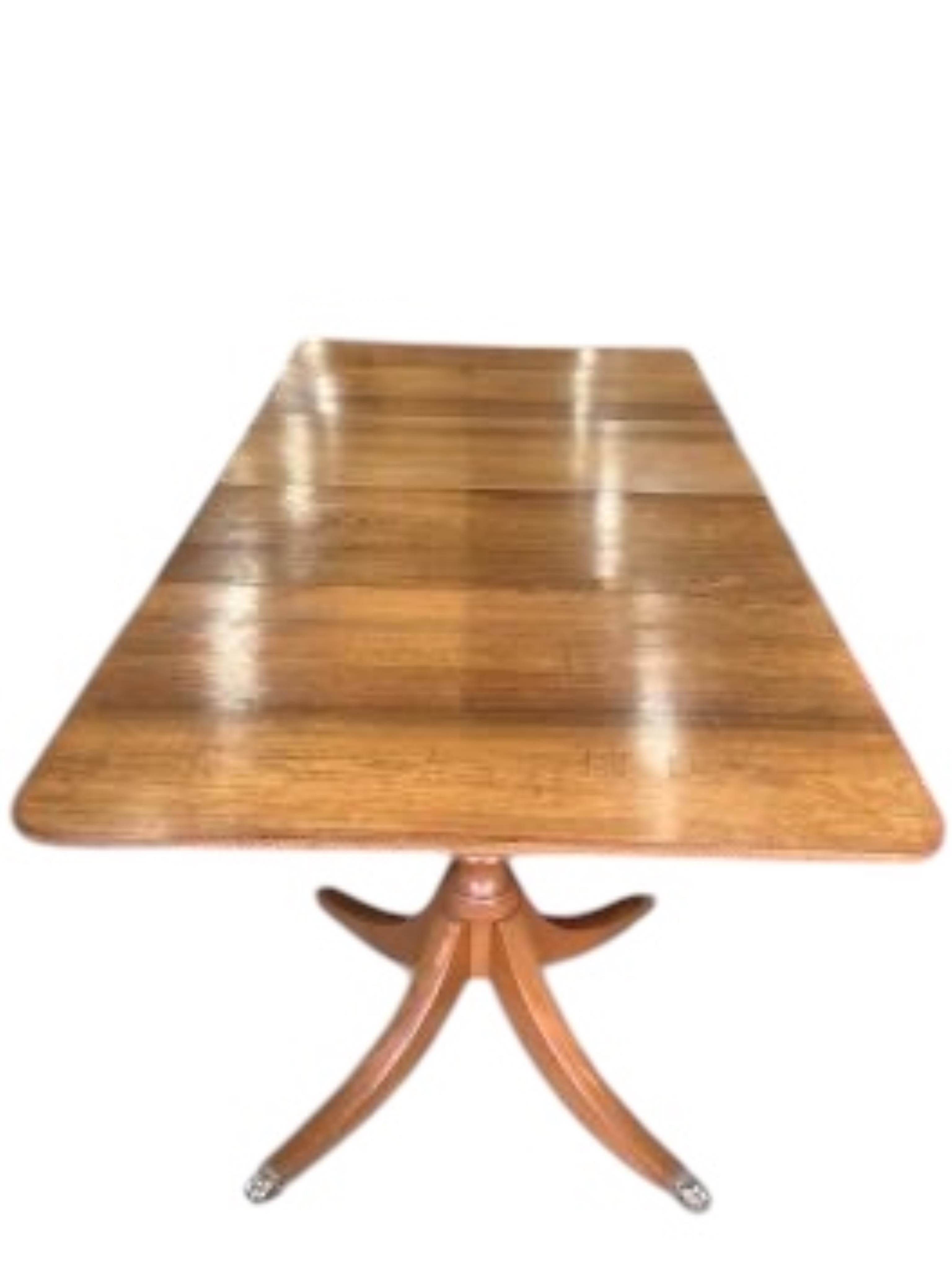 A Georgian style mahogany twin pillar extending dining table with two leaves, width 234cm extended, depth 117cm, height 74cm